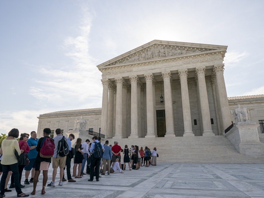 caption: Visitors lined up at the Supreme Court in Washington, D.C., on Monday morning as the justices prepared to hand down decisions.