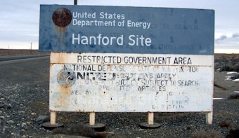 caption: Highway sign on a road entering the Hanford Site