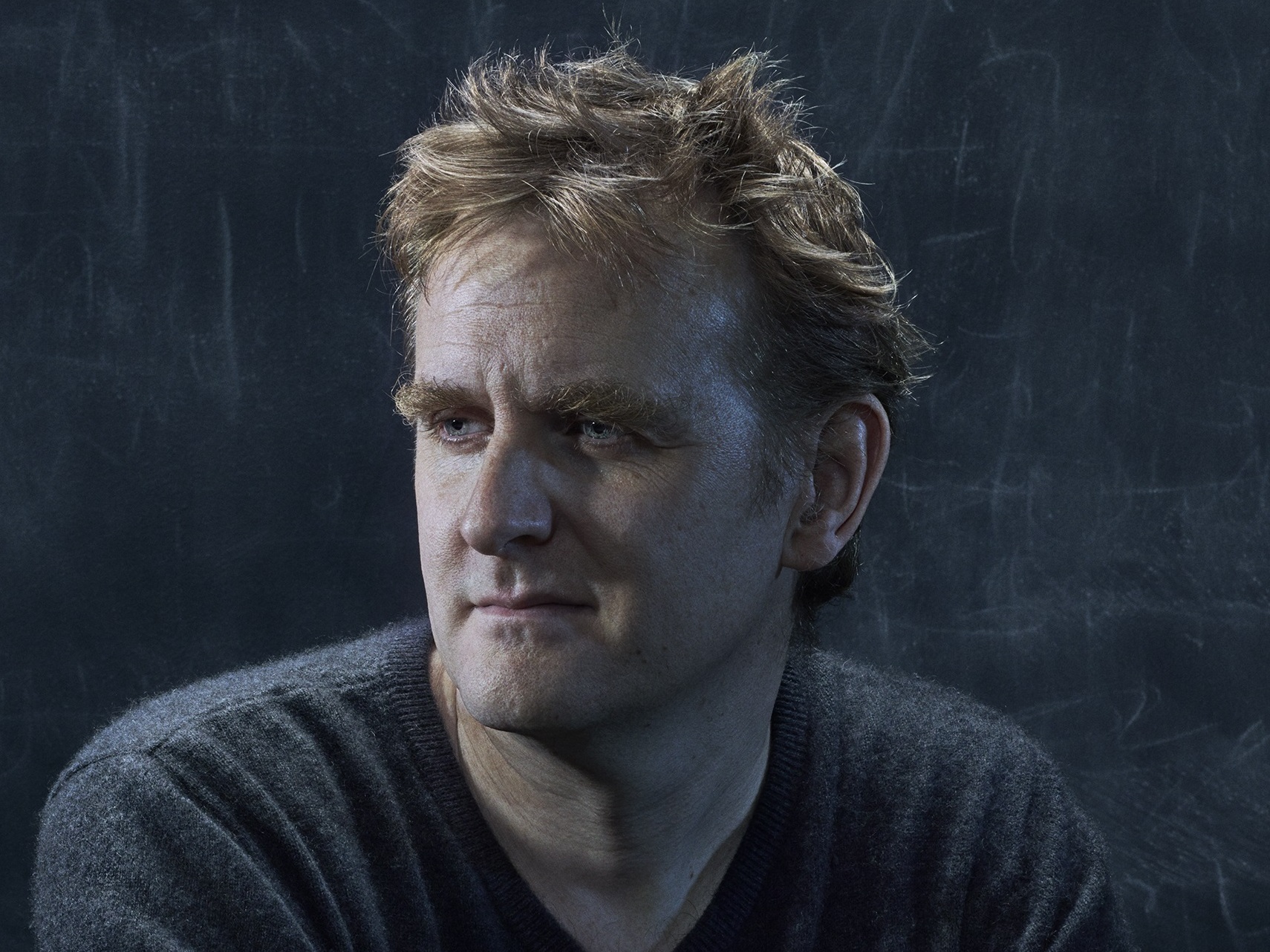 caption: "I'm not haunted by him, even in the most benign sense," Nick Harkaway says of his father, John le Carré. "I grieve occasionally. That doesn't go away. It just gets manageable."