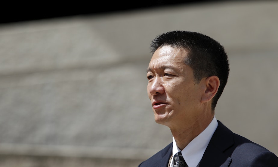 caption: Hawaii Attorney General Douglas Chin speak at a press conference outside the federal courthouse, Wednesday, March 15, 2107, in Honolulu.