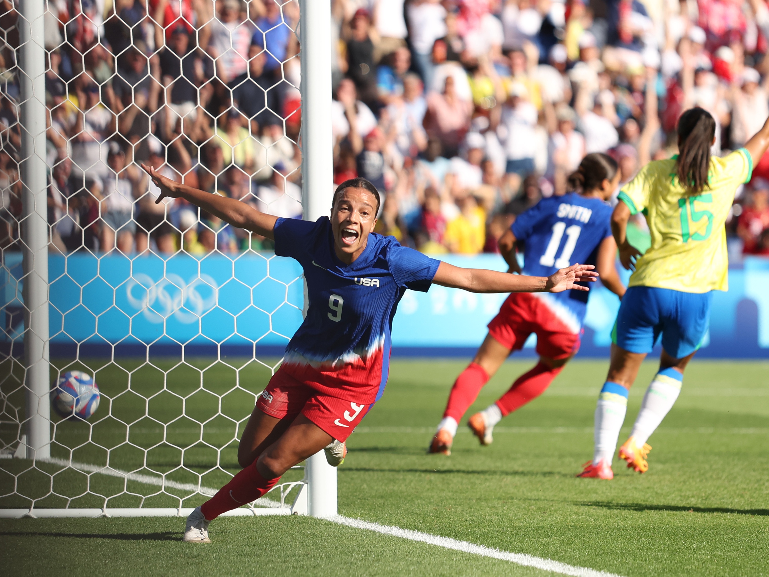caption: Mallory Swanson celebrates scoring against Brazil in the women's Gold Medal match between Brazil and United States of America Saturday at the Paris Olympics.
