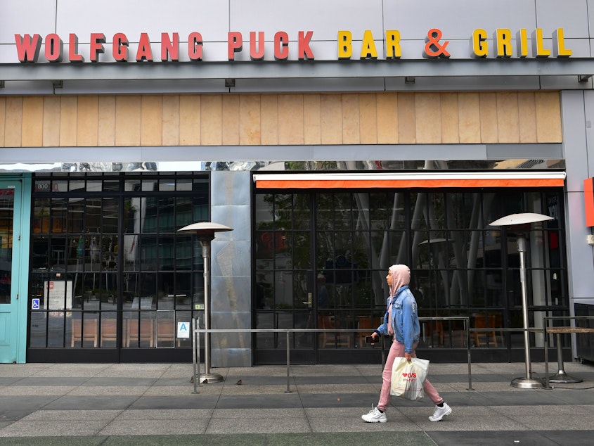 caption: A pedestrian walks past a closed Wolfgang Puck Bar & Grill restaurant in Los Angeles. President Trump has suggested changing tax deductibility law as a way of helping the restaurant industry.