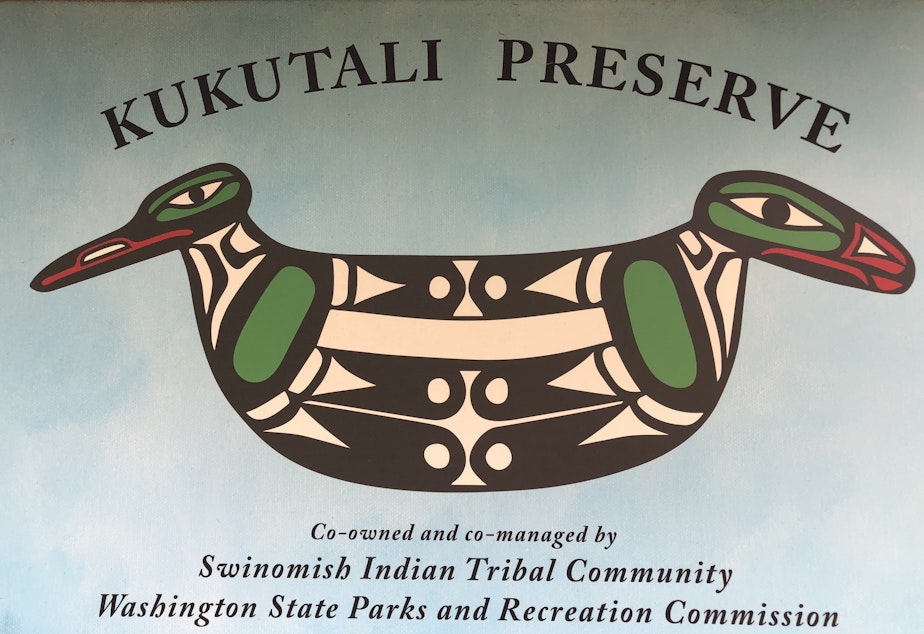 caption: Todd Mitchell created this logo for Kukutali Preserve: a hand tool adorned with two birds, representing the co-management structure for the park. 