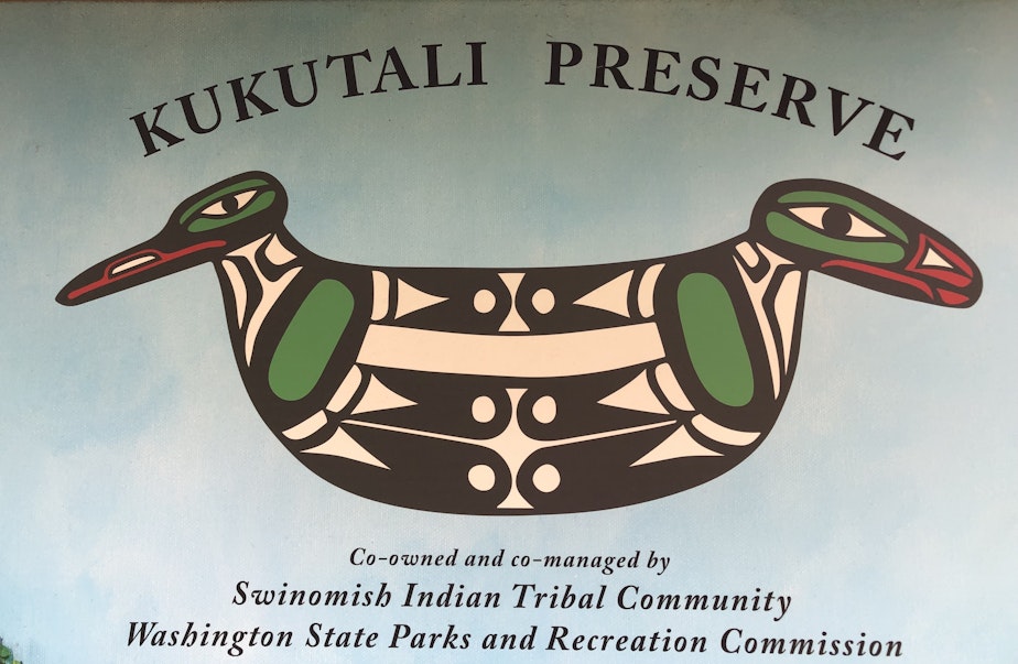 caption: Todd Mitchell created this logo for Kukutali Preserve: a hand tool adorned with two birds, representing the co-management structure for the park. 