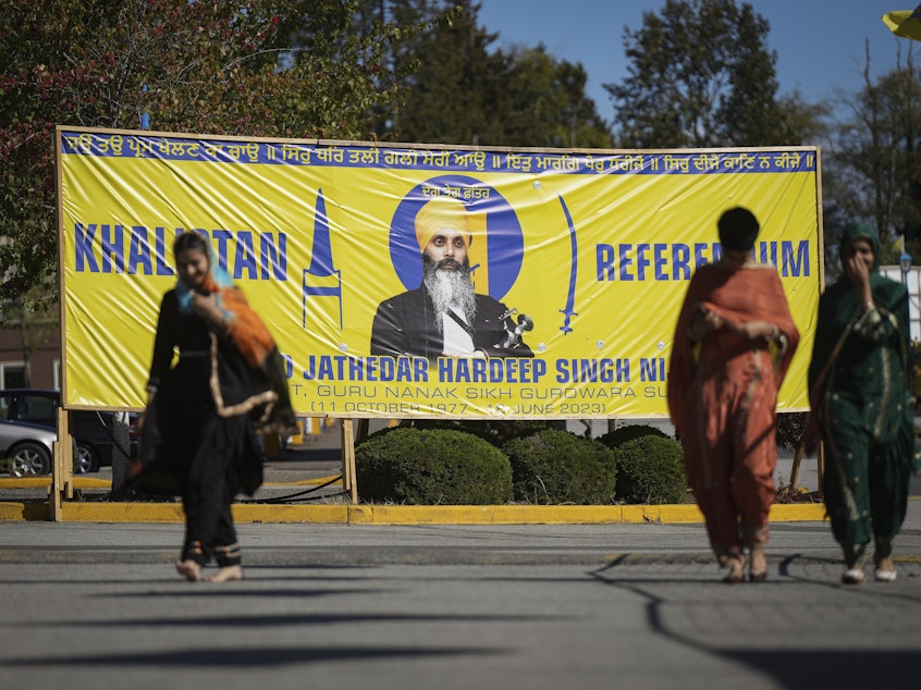 caption: A banner that shows the late Sikh separatist leader Hardeep Singh Nijjar is displayed outside the Guru Nanak Sikh Gurdwara Sahib in Surrey, British Columbia, on Sept. 18, 2023.