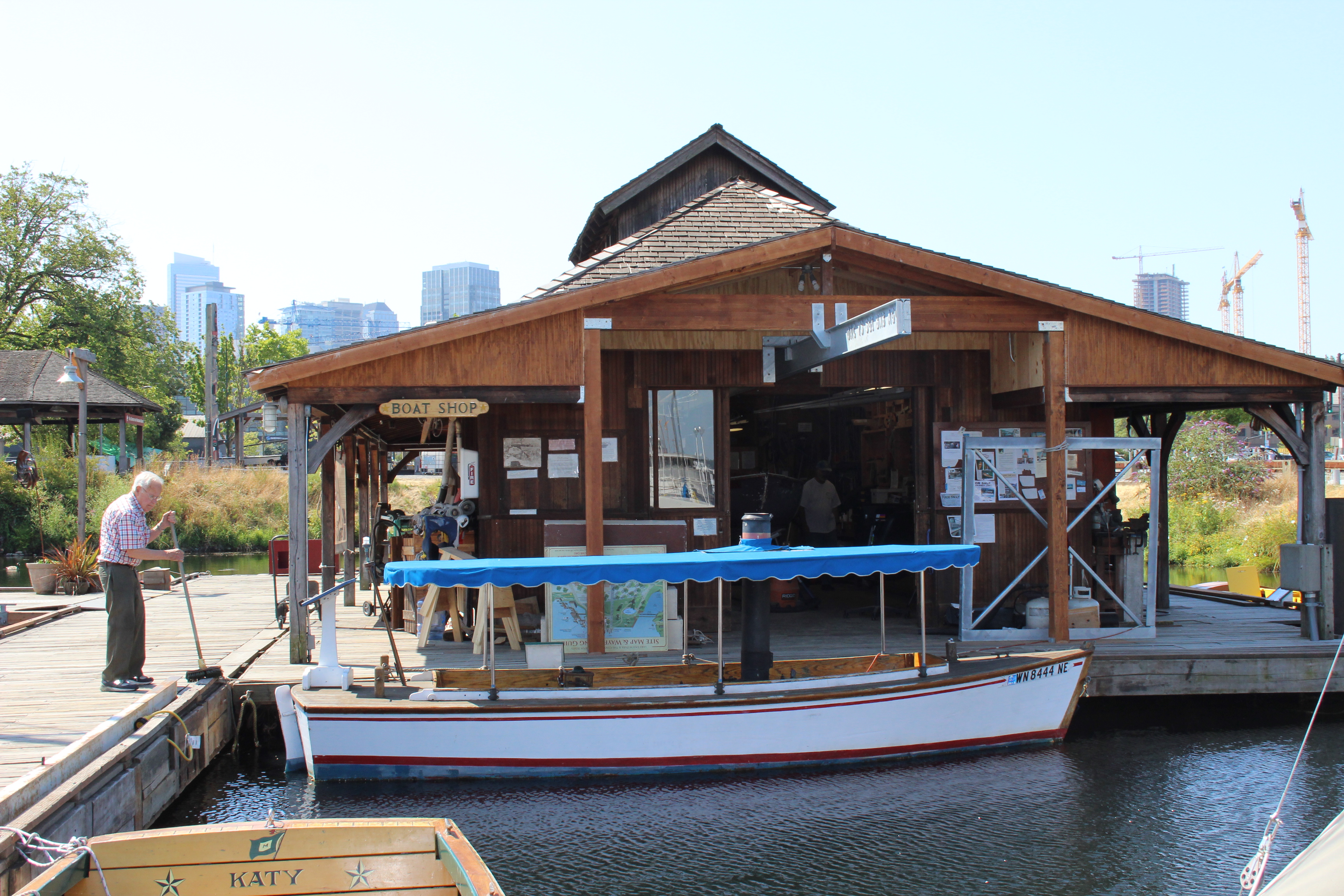 caption: The growing buildings of the South Lake Union district rise behind the Center for Wooden Boats.