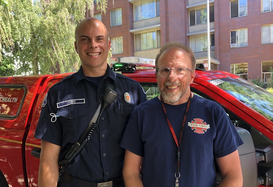 caption: Firefighter Matthew Jung, left, and caseworker Greg Jensen  check on people who recently had contact with the 911 system, as part of SFD's Health One initiative. 