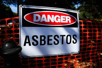 caption: An asbestos warning sign is seen at Victoria Park in in Sydney, Australia on February 29, 2024.