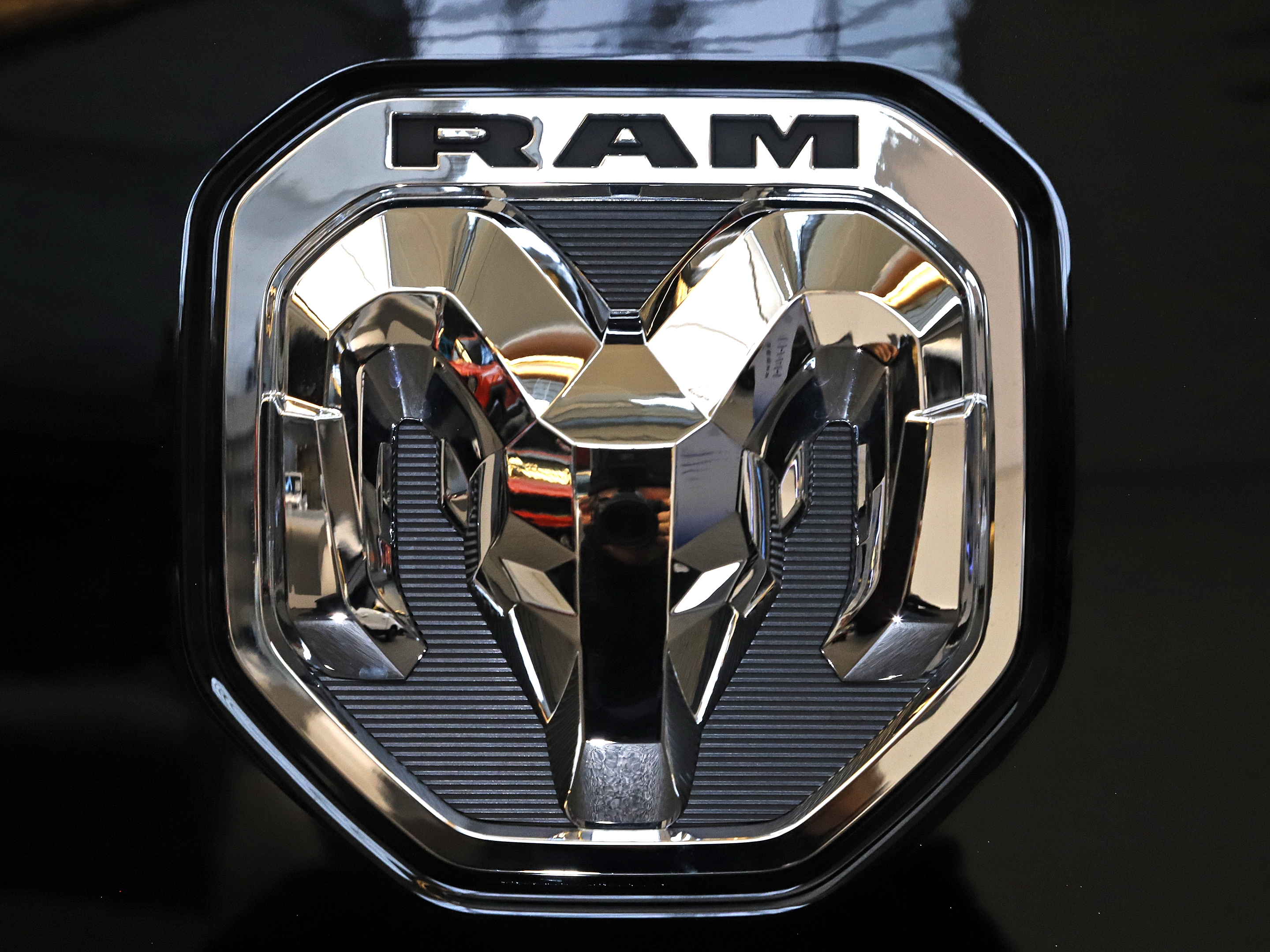 caption: A 2020 photo shows the Ram truck logo at the 2020 Pittsburgh International Auto Show in Pittsburgh.