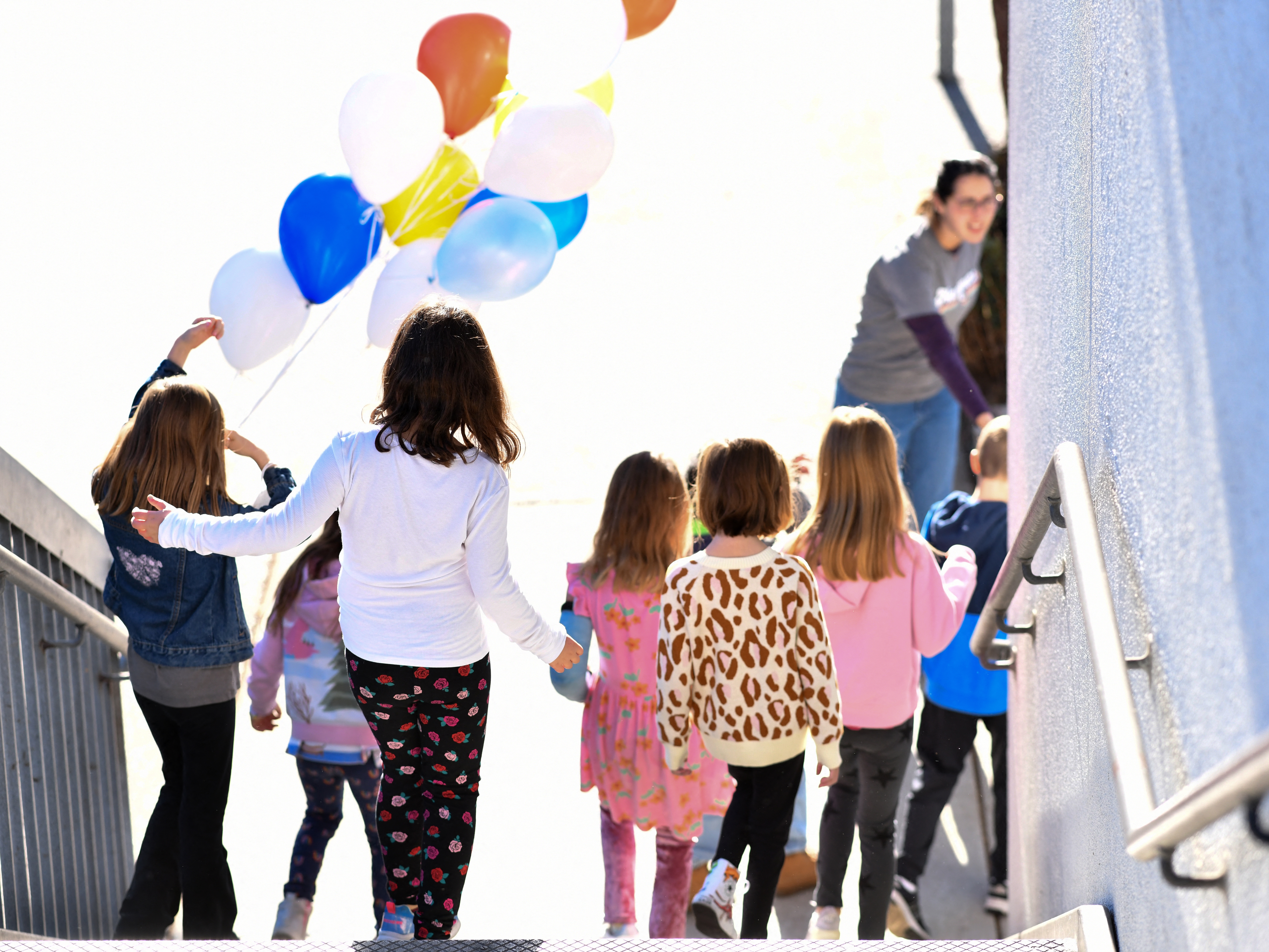 caption: A teacher gives a tour of Nora Sterry Elementary School to students in Los Angeles in January. California is one of 24 states suing the Trump administration over frozen education grant funding.
