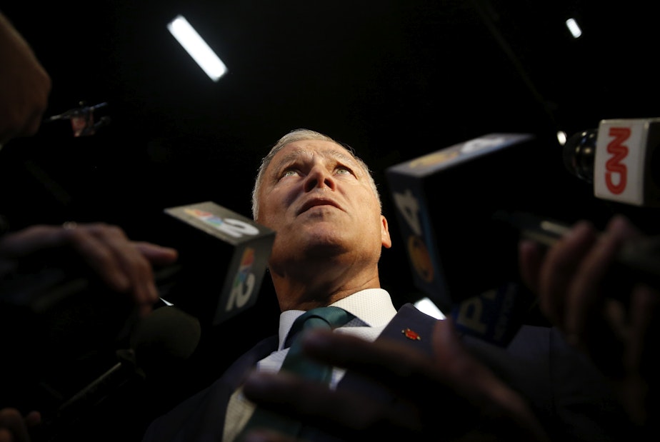 caption: Democratic presidential candidate Washington Gov. Jay Inslee, speaks to the press before the start of the Democratic primary debate hosted by NBC News at the Adrienne Arsht Center for the Performing Art, Wednesday, June 26, 2019, in Miami.