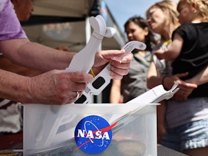 caption: People visit a NASA information booth to grab solar eclipse glasses in Russellville, Arkansas. The space agency has debunked a number of myths about the total solar eclipse — including ideas about food going bad, or unborn babies being harmed.