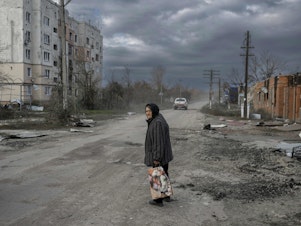 caption: An elderly woman walks in the  southern Ukrainian village of Arkhanhelske, outside Kherson, on Nov. 3. The Russians occupied the village until recently. Now Ukrainian forces are moving into villages where the Russians left. The Russians also say they're withdrawing from Kherson, marking another major setback for the Russian military.