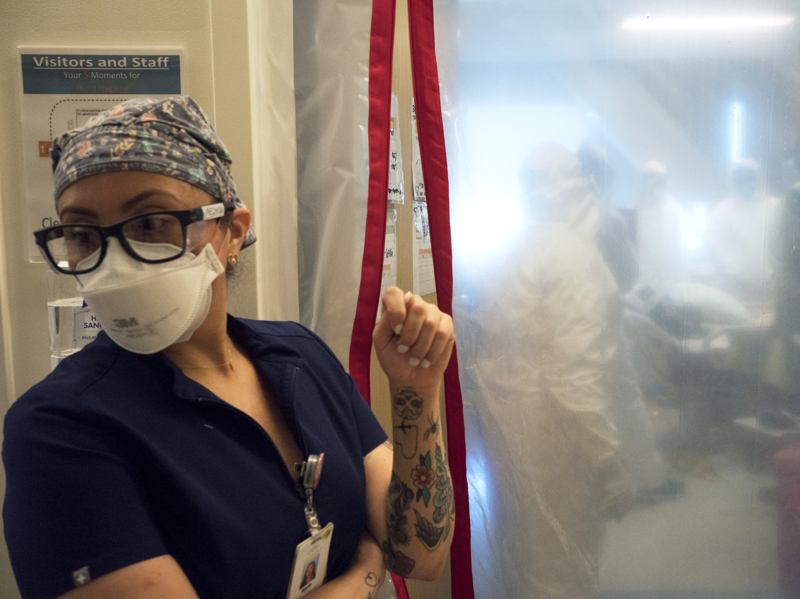 caption: Maria Arechiga, an ICU charge nurse, monitors the progress of two COVID-19 patients in the intensive care unit of Martin Luther King Jr. Community Hospital in Los Angeles.