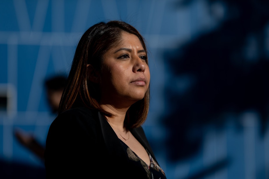 caption: Erika Castro, DACA recepient and community organizer sits outside the East Las Vegas Library in Las Vegas, Nevada, on Feb. 19, 2020. (Krystal Ramirez for Here & Now)