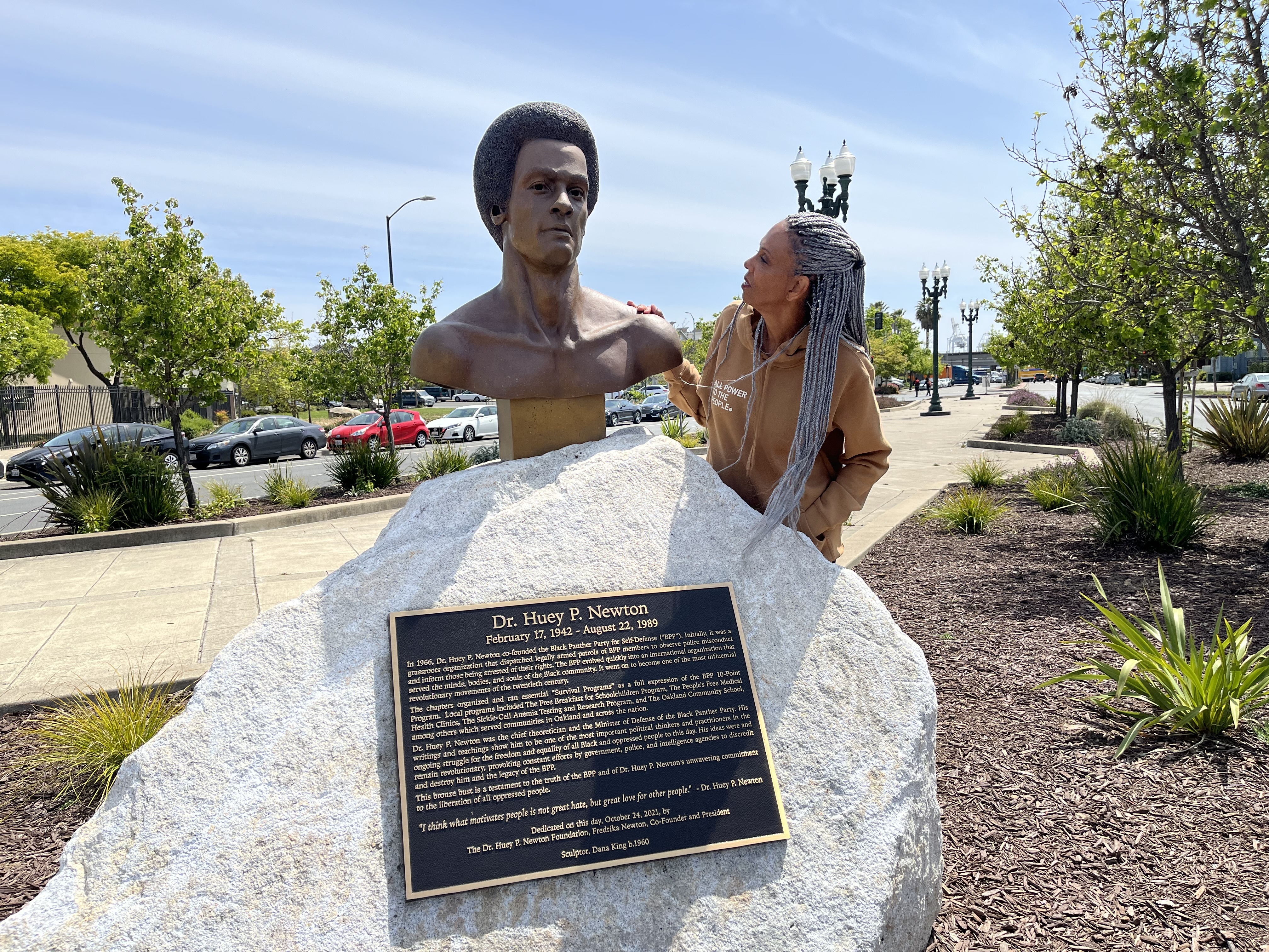 caption: Fredrika Newton stands next the bust of her late husband, Black Panther co-founder Huey P. Newton. NPS is considering a Black Panther Party National Historical Park.