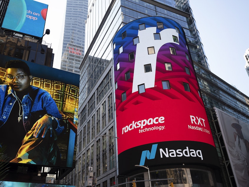 caption: A Nasdaq sign in Times Square in New York promotes an upcoming listing on Aug. 5, 2020. Nasdaq said it will push for a rule requiring listed companies to include at least one woman and one minority or LGBTQ+ person. (AP Photo/Mark Lennihan)
