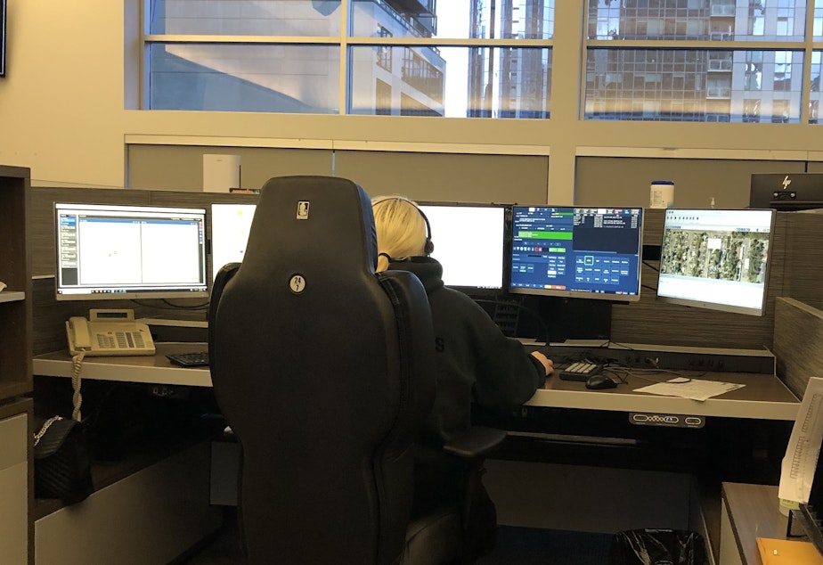 caption: A call-taker at Seattle's Community Safety and Communications Center uses five different screens to gather and enter information during 9-1-1 calls. 
