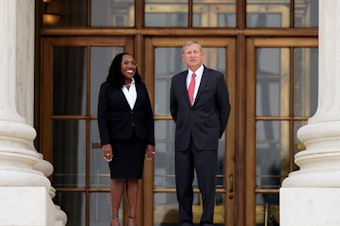 caption: Supreme Court Associate Justice Ketanji Brown Jackson stands outside the Supreme Court with Chief Justice John Roberts, following her formal investiture ceremony at the Supreme Court in Washington on Sept. 30.