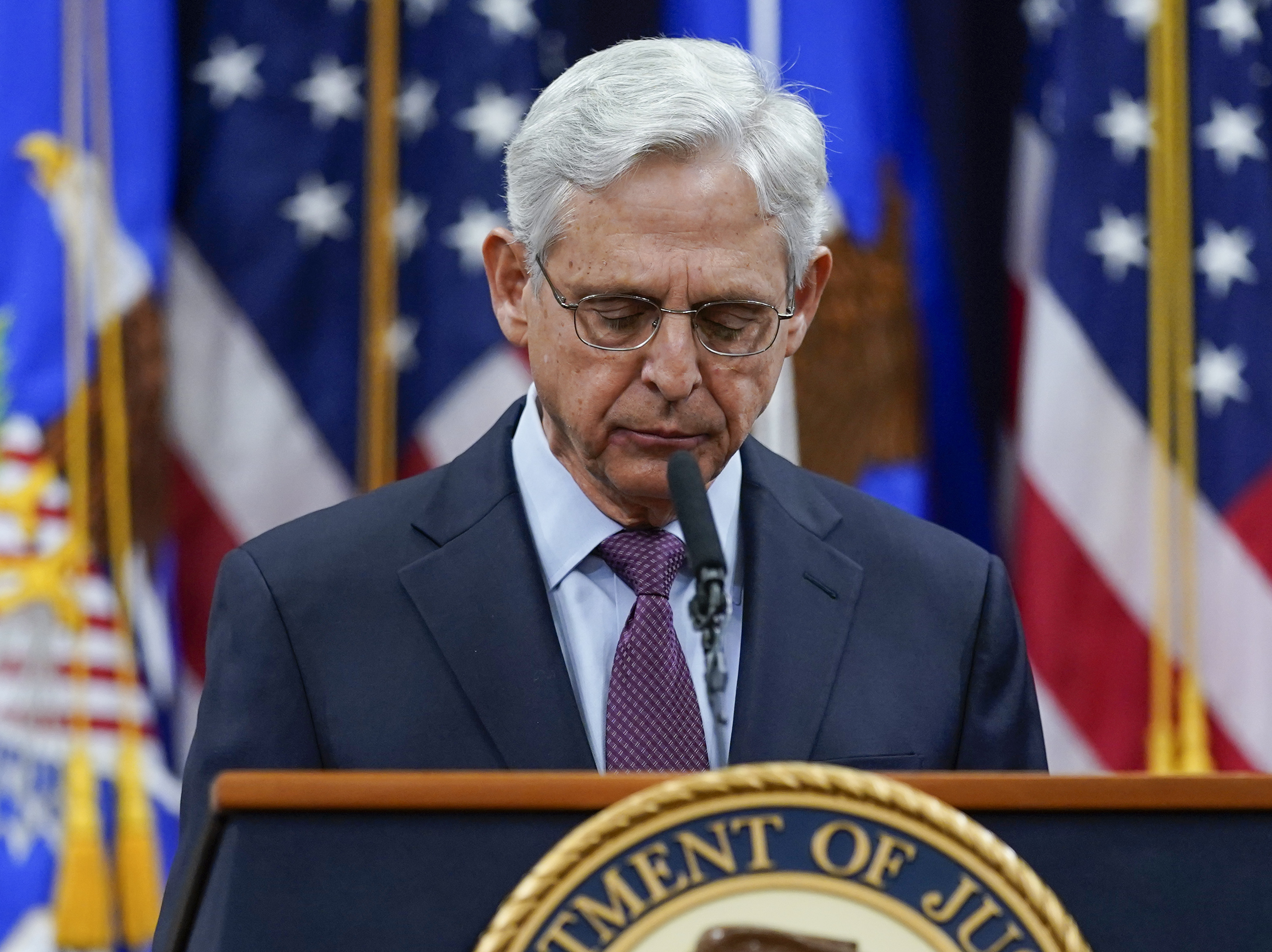 caption: Attorney General Merrick Garland pauses as he speaks at the Department of Justice in Washington on Wednesday, in advance of the one year anniversary of the attack on the U.S. Capitol.