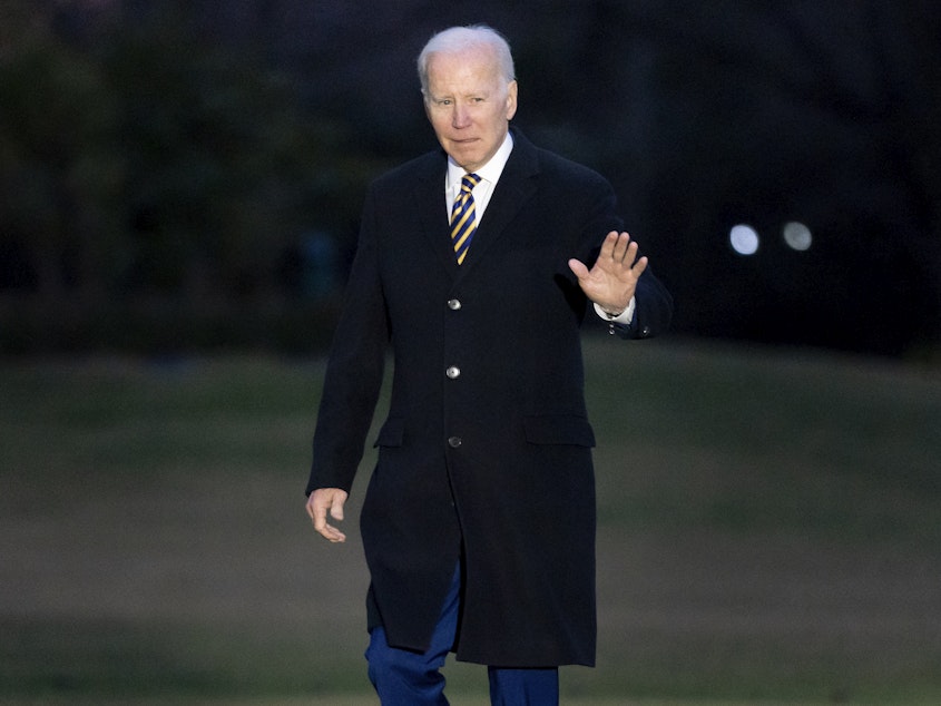 caption: President Joe Biden walks across the South Lawn of the White House in Washington on Tuesday.