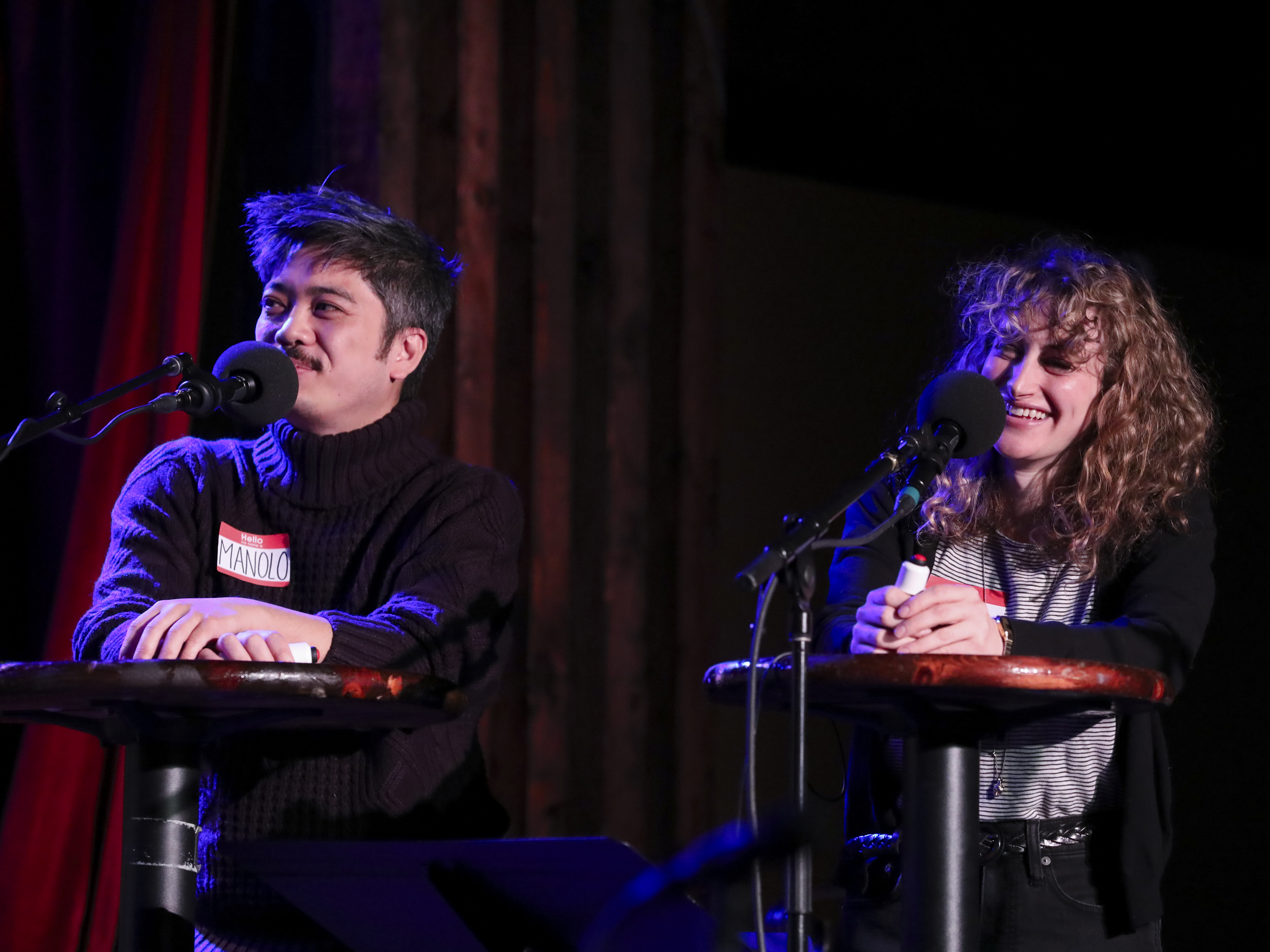 caption: Podcast hosts Manolo Moreno and Jo Firestone face-off in a game on <em>Ask Me Another, </em>as part of the Brooklyn Podcast Festival at the Bell House in New York.