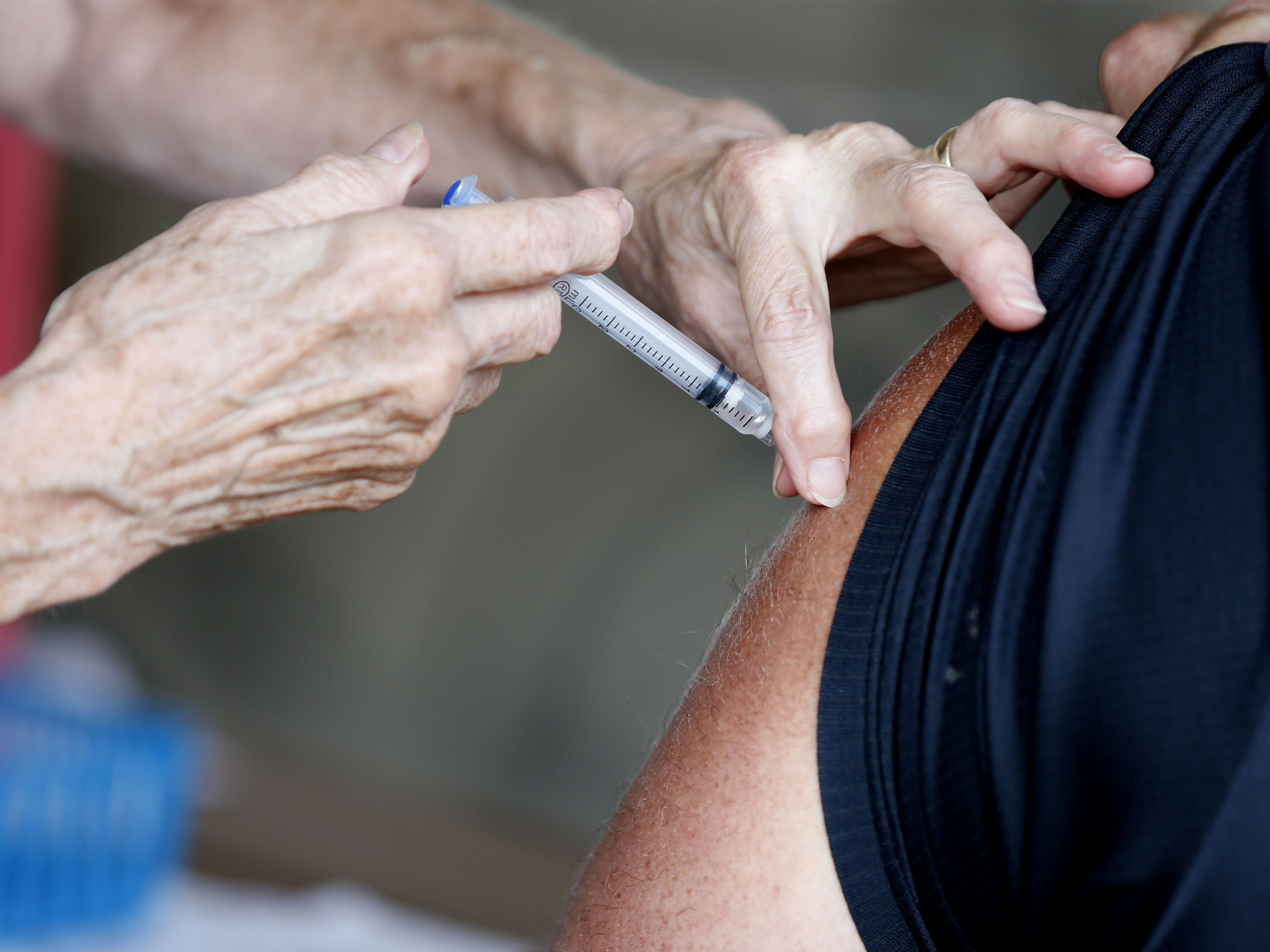caption: A man receives a COVID-19 vaccine at a clinic in Springfield, Mo., in June. Vaccination rates in southern Missouri are low, a factor officials say is helping drive what's now the nation's largest outbreak.
