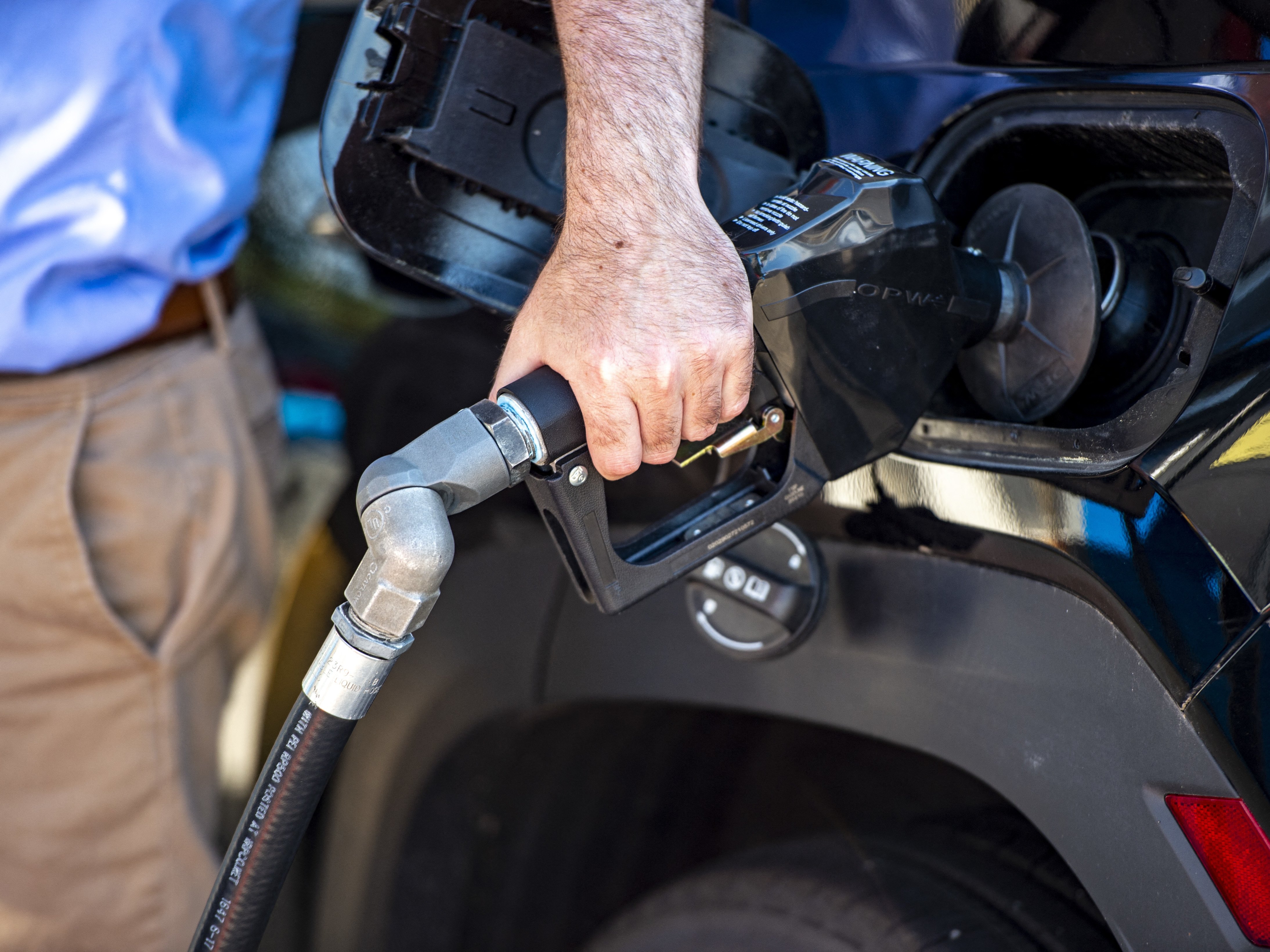 caption: A driver pumps gas at a Gulf gas station in Lynnfield, Mass., on July 19. Gasoline prices are dropping, which is helping bring down inflation. But the cost of many other things are still climbing.