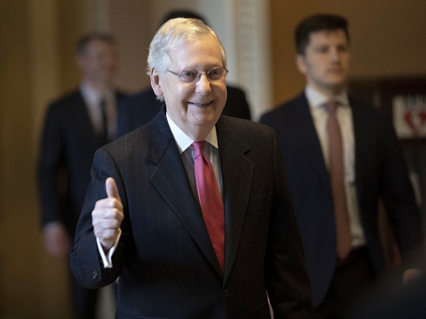 caption: Senate Majority Leader Mitch McConnell gives a thumbs up sign after speaking on the floor Wednesday.