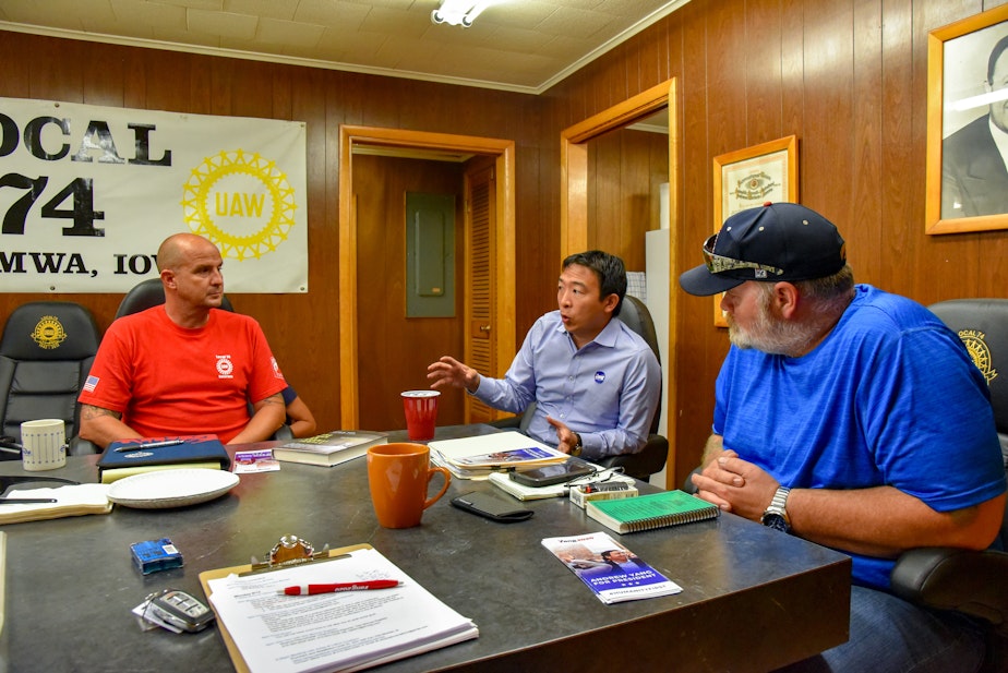 caption: Andrew Yang meets with union leaders with the United Auto Workers in Iowa 