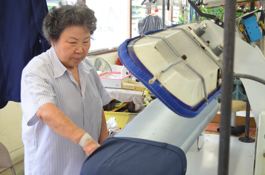 caption: Hyen Sook Kang works in her Wallingford business, Sun Dry Cleaners. She says that since switching to wet cleaning process she's been feeling better.