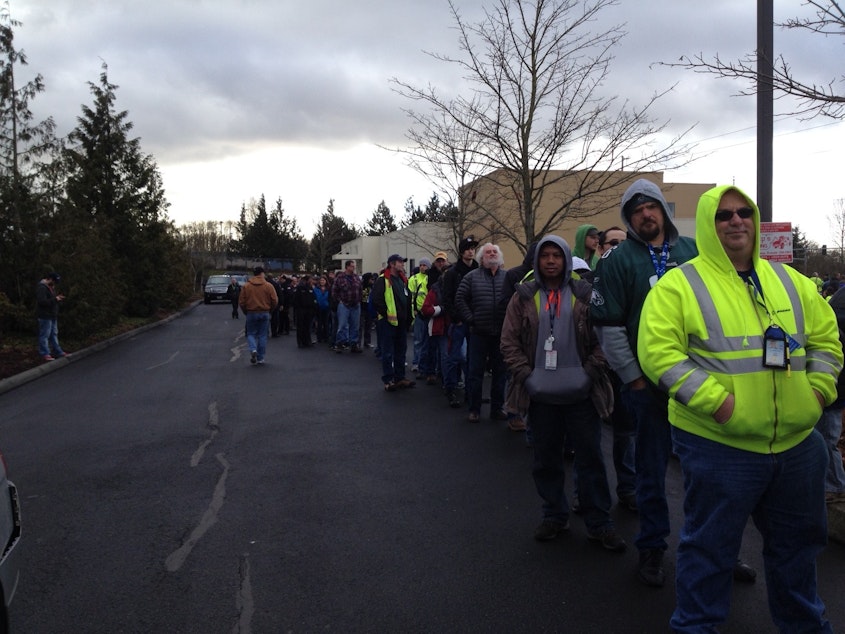 caption: Boeing machinists line up in Everett to vote on a contract offer Friday. 