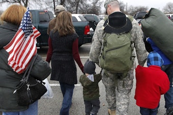 caption: In this Dec. 24, 2011 file photo, a soldier walks with his family following a ceremony at Fort Hood, Texas, for soldiers from the U.S. Army 1st Cavalry 3rd Brigade, who returned home from deployment in Iraq.