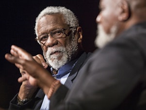 caption: Russell attends a civil rights summit at the LBJ Presidential Library in 2014 in Austin, Texas. During and after his NBA career, Russell spoke out often about civil rights issues.
