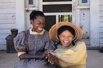 caption: Young Celie (Phylicia Pearl Mpasi) and young Nettie (Halle Bailey) share an unbreakable bond.