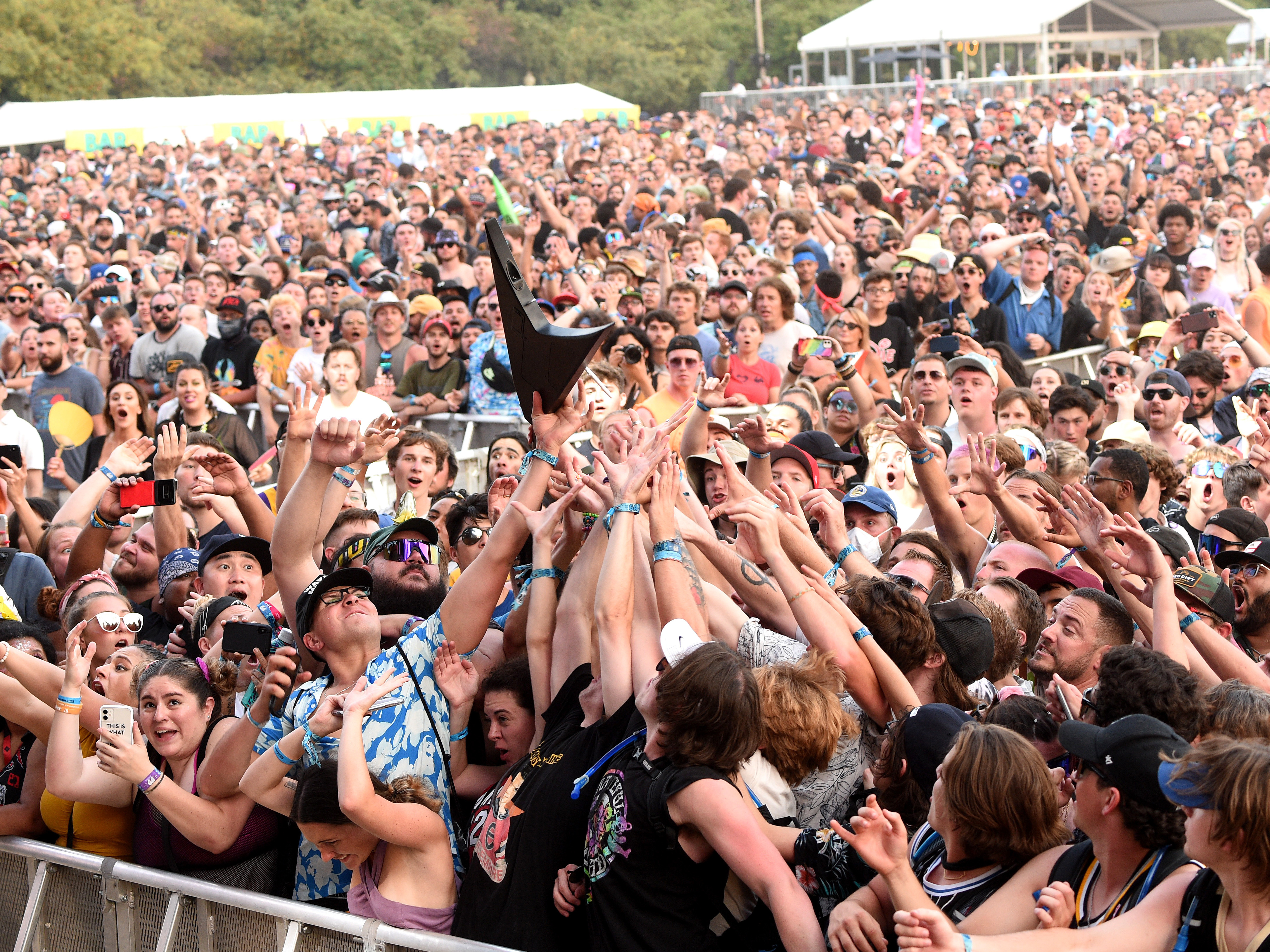 caption: The crowd catches Wes Borland's guitar during the Lollapalooza music festival last weekend at Grant Park in Chicago.