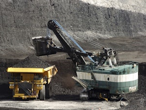caption: FILE - A mechanized shovel loads a haul truck that can carry up to 250 tons of coal at the Spring Creek coal mine, April 4, 2013, near Decker, Mont. On Wednesday, Feb. 21, 2024, a U.S. appeals court struck down a judge's 2022 order that imposed a moratorium on coal leasing from federal lands. (AP Photo/Matthew Brown, File)