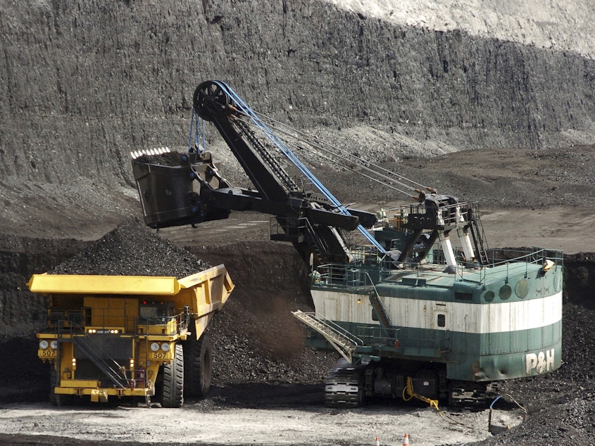 caption: FILE - A mechanized shovel loads a haul truck that can carry up to 250 tons of coal at the Spring Creek coal mine, April 4, 2013, near Decker, Mont. On Wednesday, Feb. 21, 2024, a U.S. appeals court struck down a judge's 2022 order that imposed a moratorium on coal leasing from federal lands. (AP Photo/Matthew Brown, File)