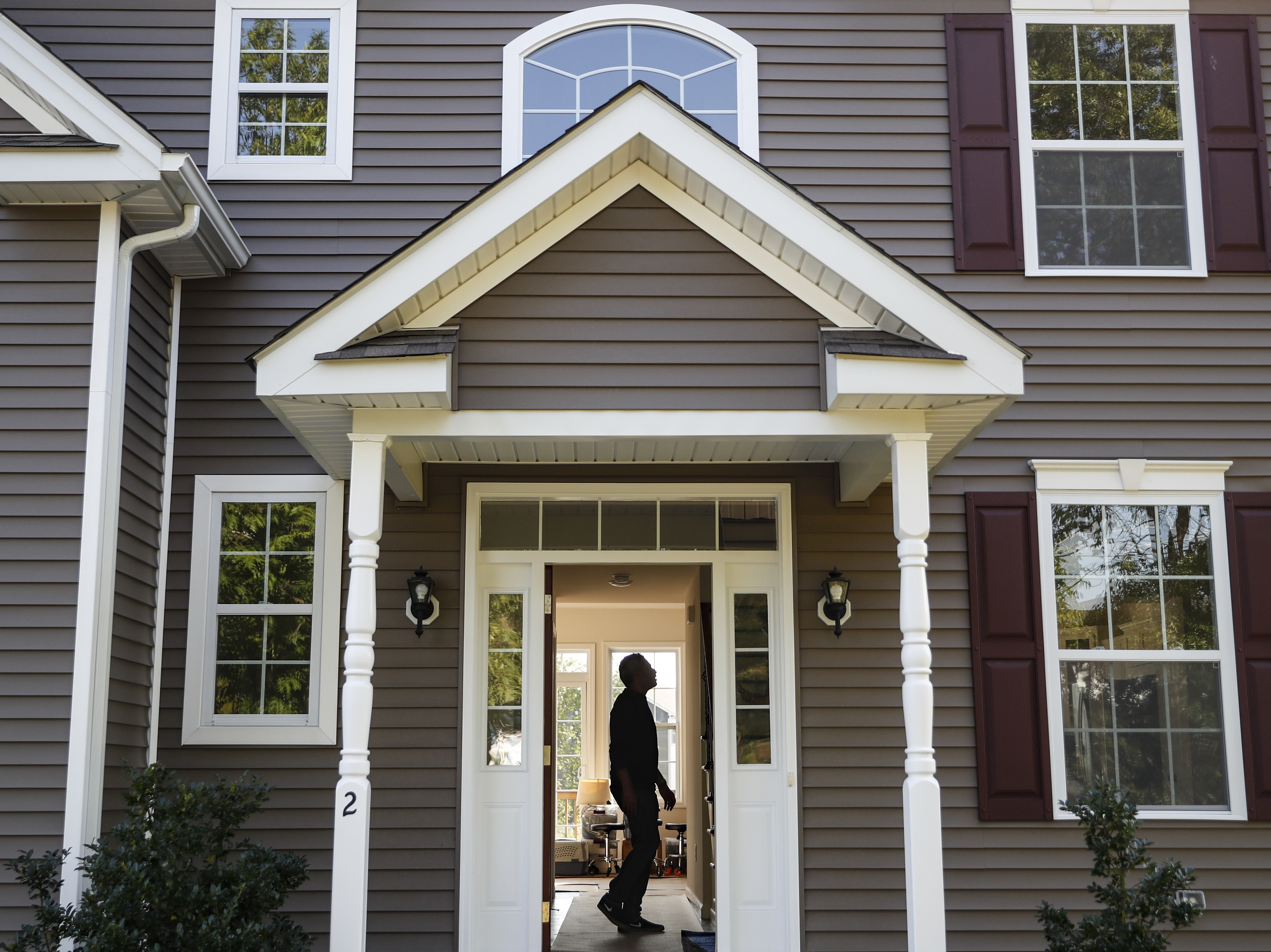 caption: A new homeowner tours his new place in Washingtonville, N.Y., this month.