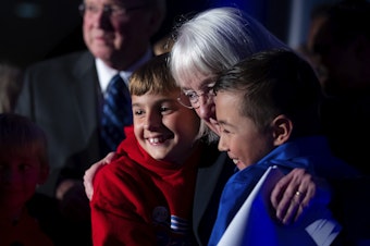 caption: Senator Patty Murray celebrates with family on stage after speaking to supporters during an election night party on Tuesday, November 8, 2022, at the Westin in Bellevue.  