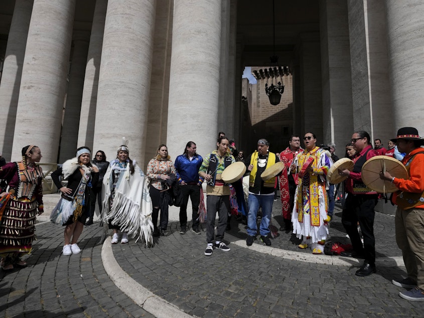 caption: Indigenous artists from across Canada perform in St.Peter's Square, at the Vatican, on Friday after Pope Francis apologized for the Catholic Church's actions in Canadian residential schools.