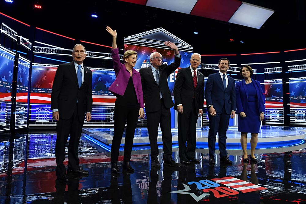 caption: Democratic presidential candidates (L-R) former New York City Mayor Mike Bloomberg, Sen. Elizabeth Warren (D-MA), Sen. Bernie Sanders (I-VT), former Vice President Joe Biden, former South Bend, Indiana Mayor Pete Buttigieg, and Sen. Amy Klobuchar (D-MN) arrive on stage for the Democratic presidential primary debate at Paris Las Vegas on February 19, 2020 in Las Vegas, Nevada. (Ethan Miller/Getty Images)