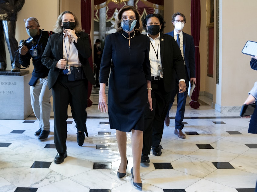 caption: House Speaker Nancy Pelosi, D-Calif., said that impeaching President Trump is "a constitutional remedy that will ensure that the republic will be safe from this man." She's seen here walking to the House floor on Wednesday, ahead of the vote.