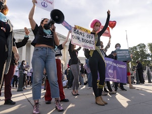 caption: Pro-abortion rights and anti-abortion activists rally outside the Supreme Court on Monday, as the justices heard arguments about Texas's controversial abortion law.