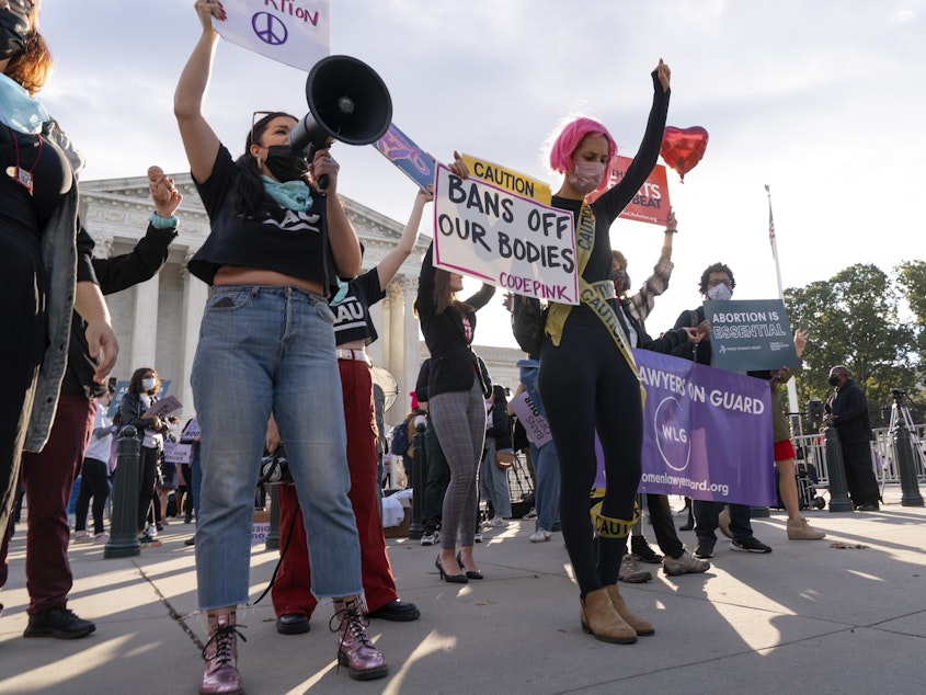 caption: Pro-abortion rights and anti-abortion activists rally outside the Supreme Court on Monday, as the justices heard arguments about Texas's controversial abortion law.