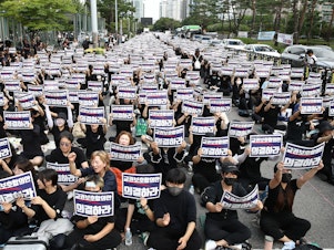 caption: South Korean teachers participate in a rally in front of the National Assembly on Sept. 4, 2023 in Seoul, South Korea. School teachers rallied to mourn the recent suicide deaths of fellow teachers distressed by disgruntled parents and unruly students, and to call for measures to prevent such tragedies.