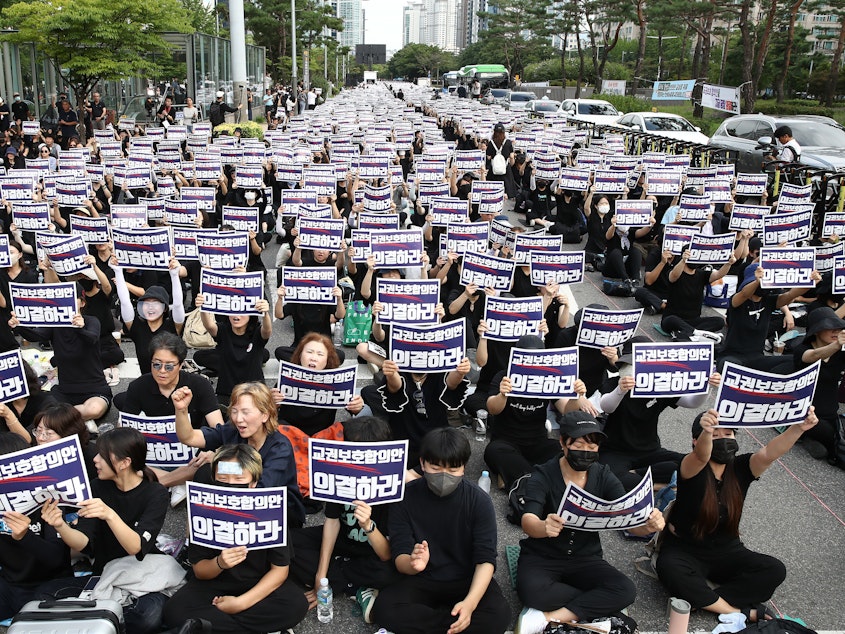 caption: South Korean teachers participate in a rally in front of the National Assembly on Sept. 4, 2023 in Seoul, South Korea. School teachers rallied to mourn the recent suicide deaths of fellow teachers distressed by disgruntled parents and unruly students, and to call for measures to prevent such tragedies.