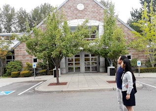 caption: Natasha and Brent Weled in front of the King County District courthouse in Issaquah, where they presented a case against Allied Residential, their former landlord.