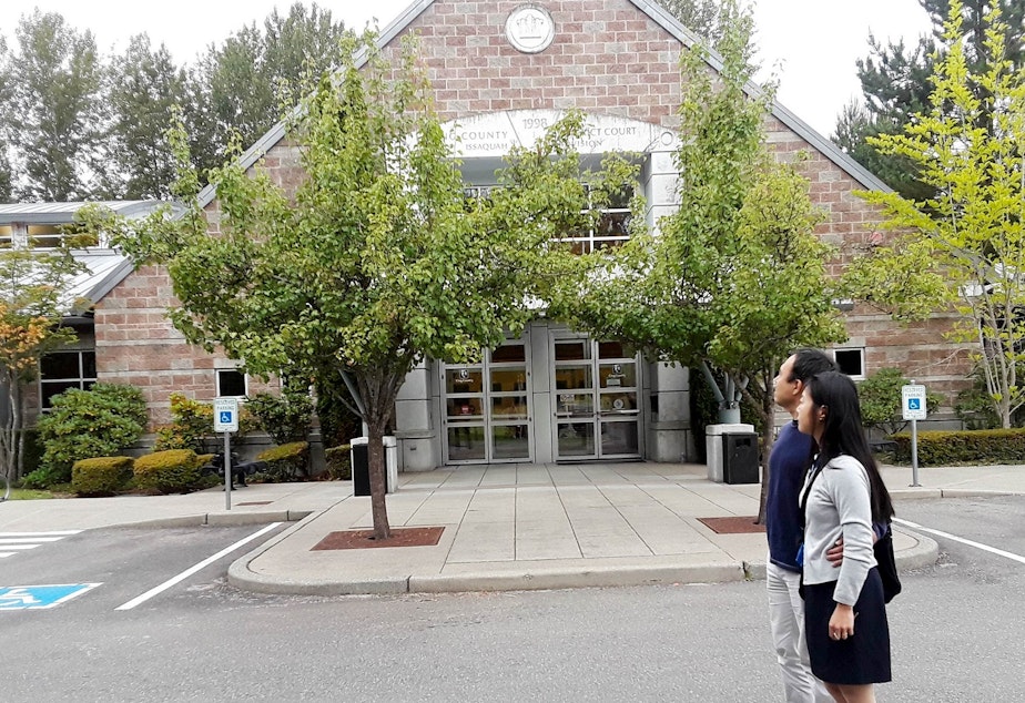 caption: Natasha and Brent Weled in front of the King County District courthouse in Issaquah, where they presented a case against Allied Residential, their former landlord.