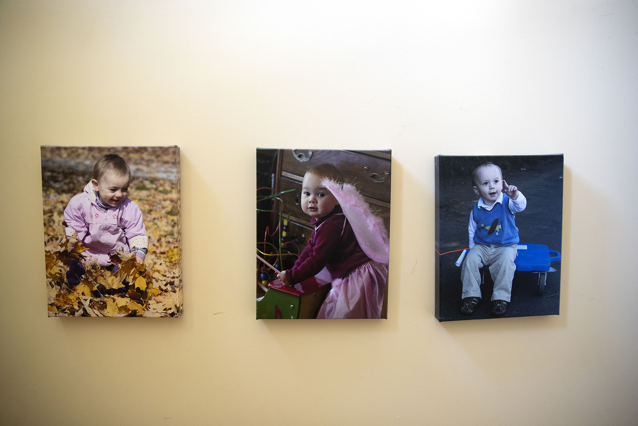 caption: Photographs of Marianne Bryan’s three children are displayed in the stairwell of her home on Friday, Nov. 7, 2025, in Seattle. 